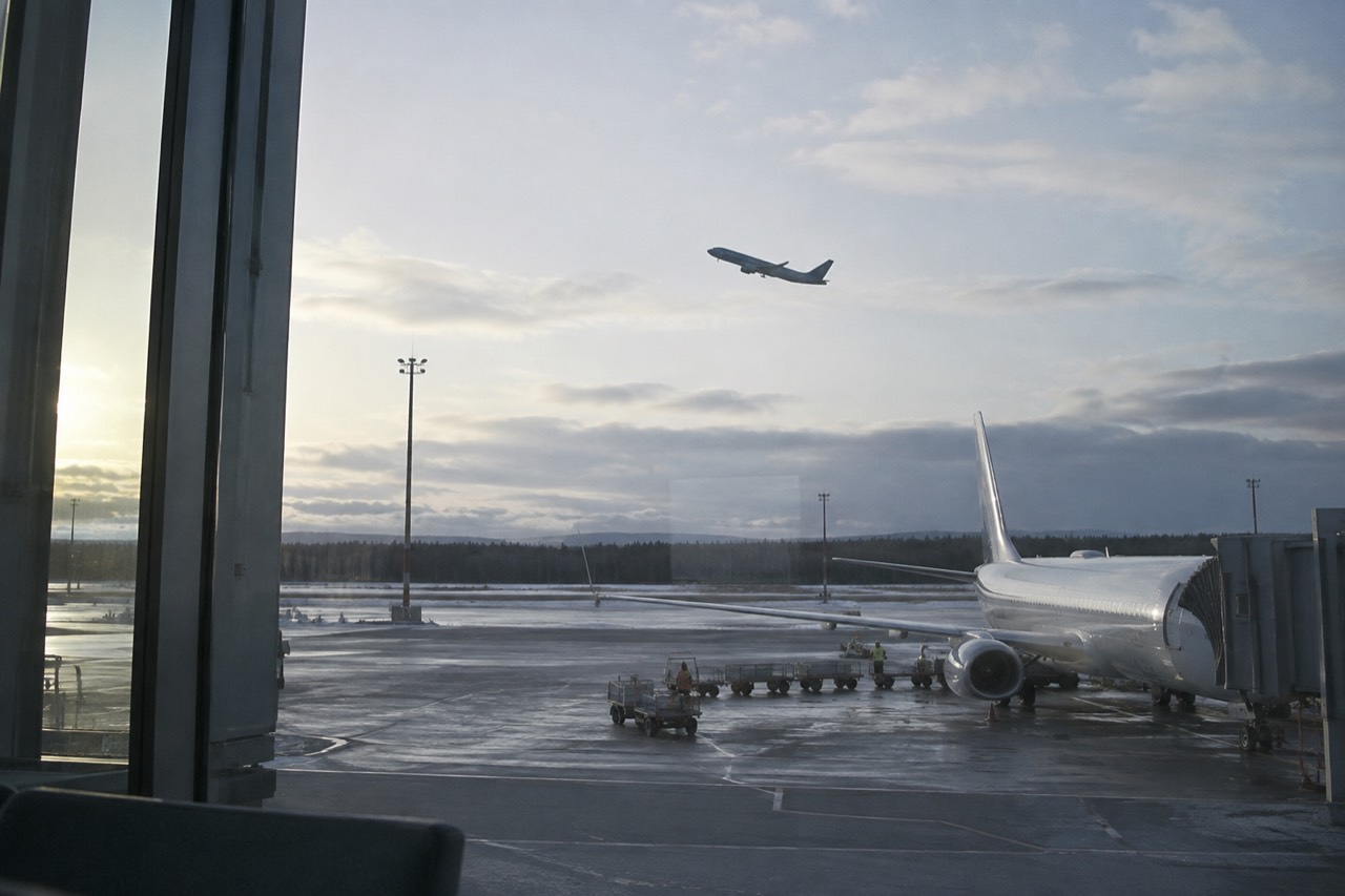 An airplane climbing above Oslo Airport Gardermoen on a bright morning