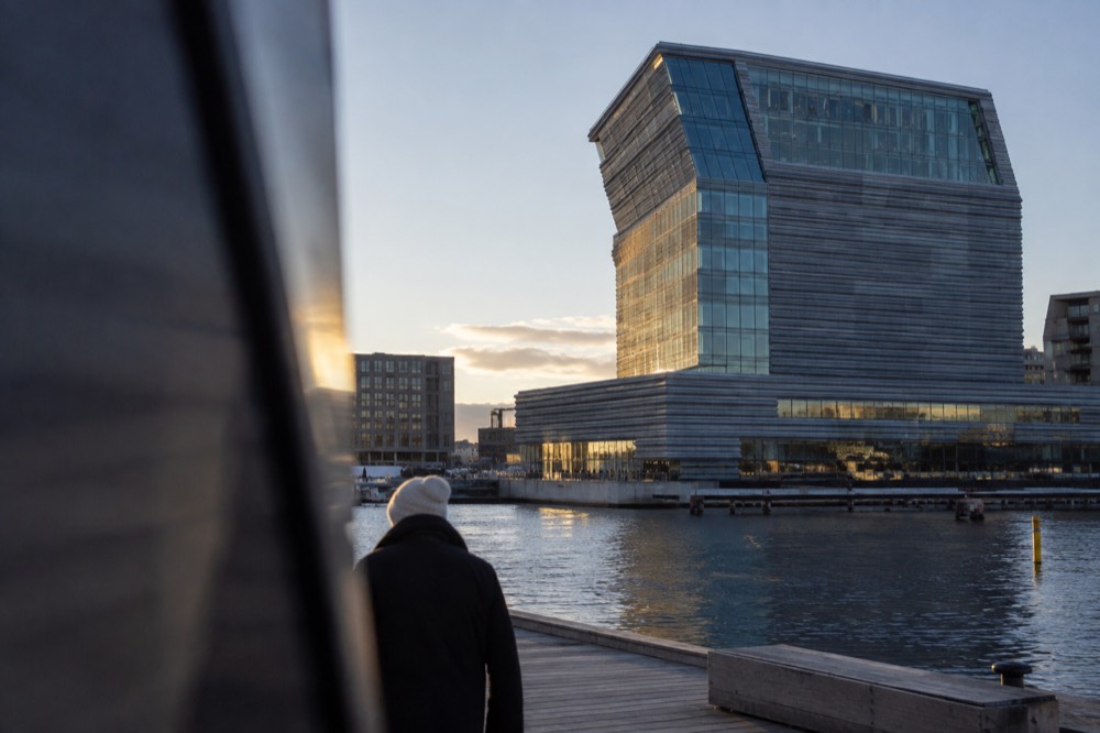 The glass facade of the MUNCH museum beside the Oslofjord waterfront at Bjørvika