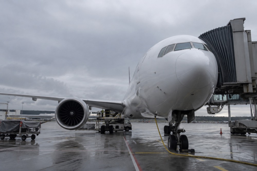 A commercial aircraft parked at a terminal gate at Oslo Airport Gardermoen