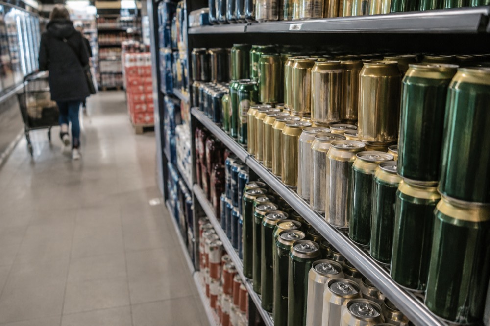 Supermarket shelves stocked with cans of beer in a Norwegian grocery store