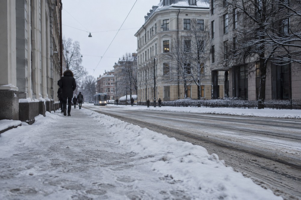 Snow covered street in central Oslo under low winter light