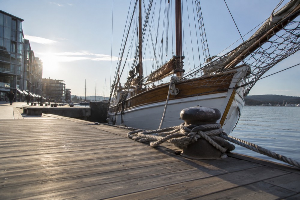 Wooden sailing ship moored at Aker Brygge in the Oslo sunshine