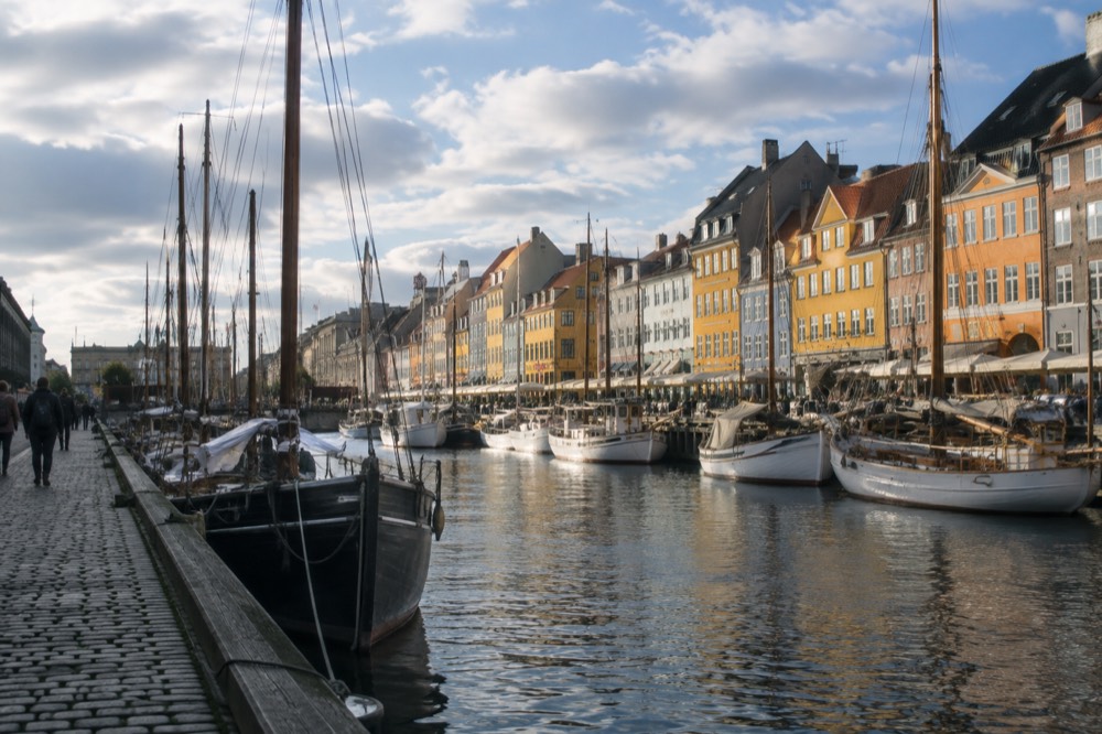 Nyhavn canal in Copenhagen with colorful townhouses and wooden masts