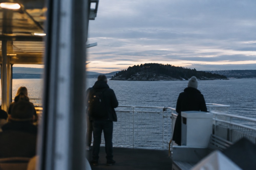 Ferry approaching a small forested island in the Oslofjord