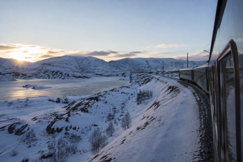 A passenger train crossing a high mountain plateau between Oslo and Bergen