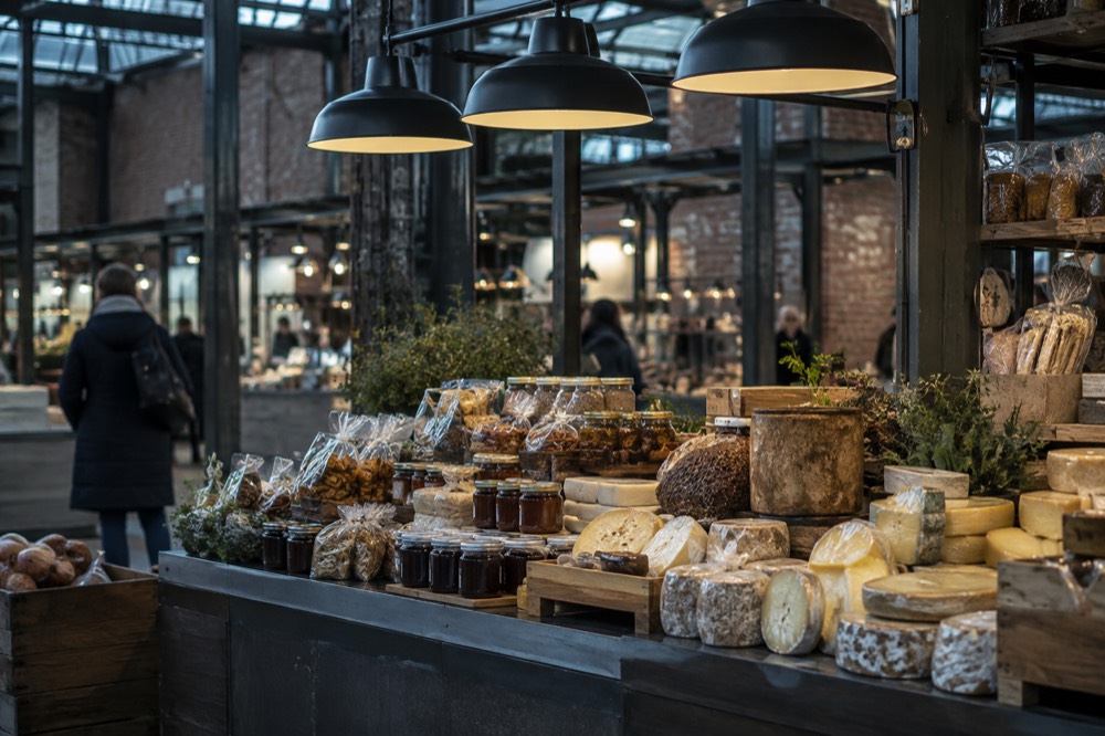 A food hall counter displaying Norwegian cheeses, jams and packaged food gifts
