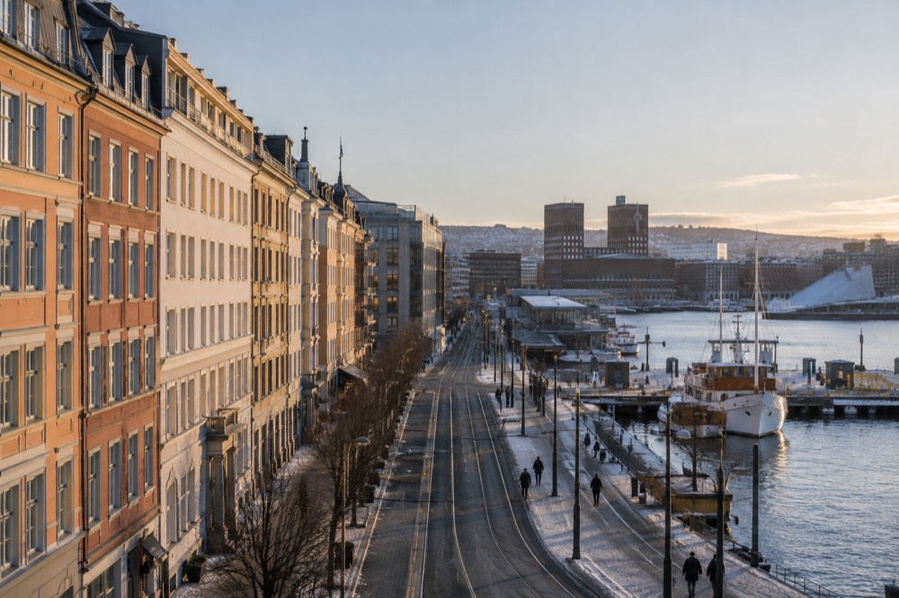 Colorful historic buildings along a waterfront street in central Oslo