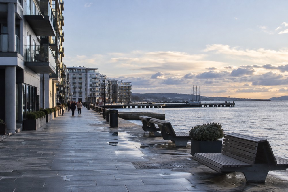 Modern apartment buildings and a promenade along the Oslofjord waterfront