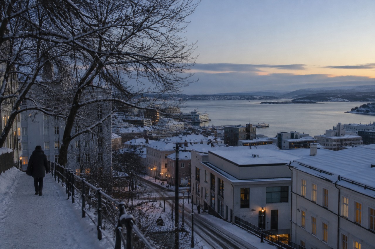 Snow-covered rooftops of Oslo seen across the Oslofjord on a calm winter morning