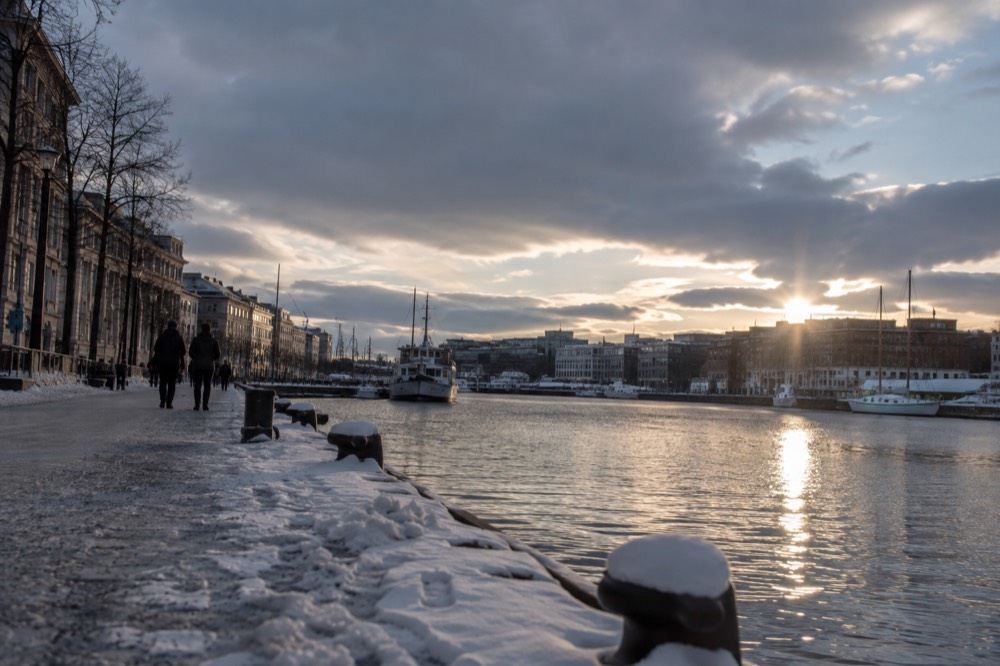 City lights of Oslo reflected in the harbor on a winter evening