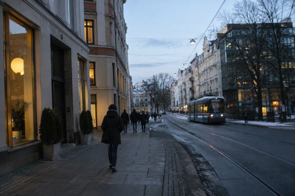 Shopfront signs in Norwegian on a colorful street in central Oslo