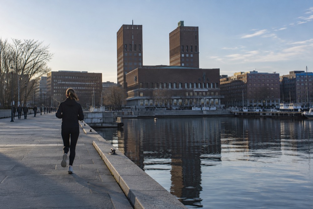 Oslo City Hall facade reflected in the fjord water