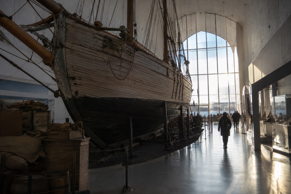 A wooden polar expedition ship displayed inside a museum hall
