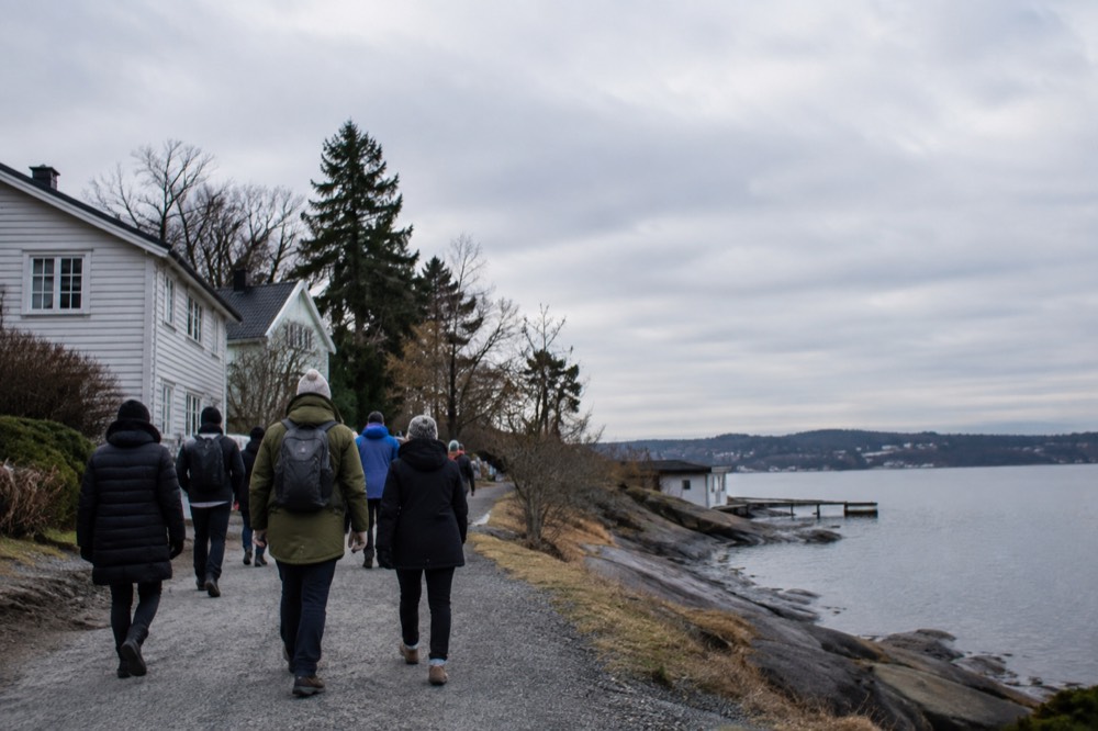 A group of walkers with a guide on a city street near the waterfront
