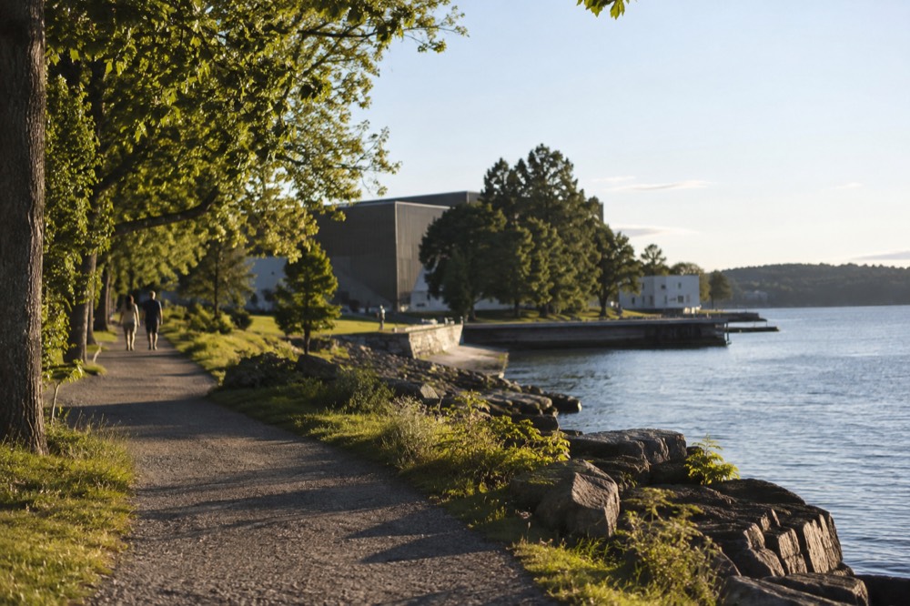 Museum buildings and trees under a bright summer sky by the water