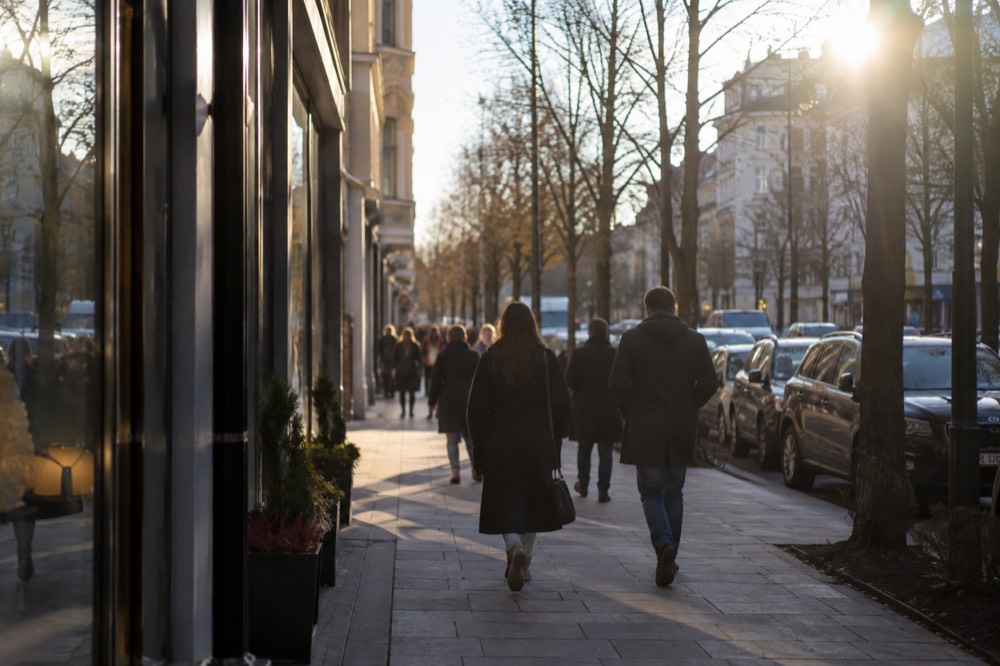 Shoppers walking along Bogstadveien with storefronts on both sides