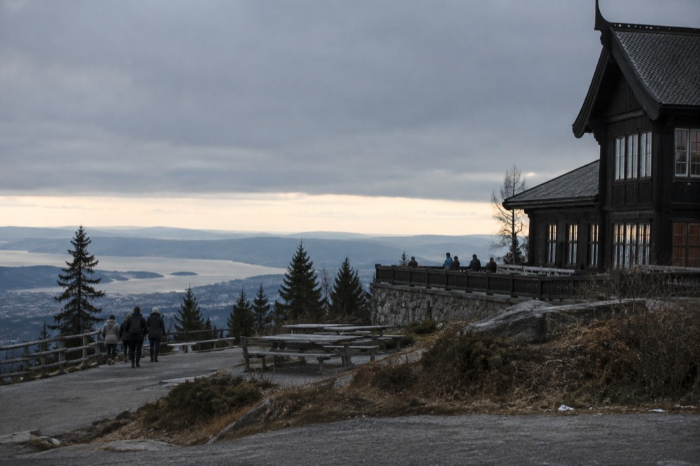 The wooden café building and terrace at Frognerseteren above the forest