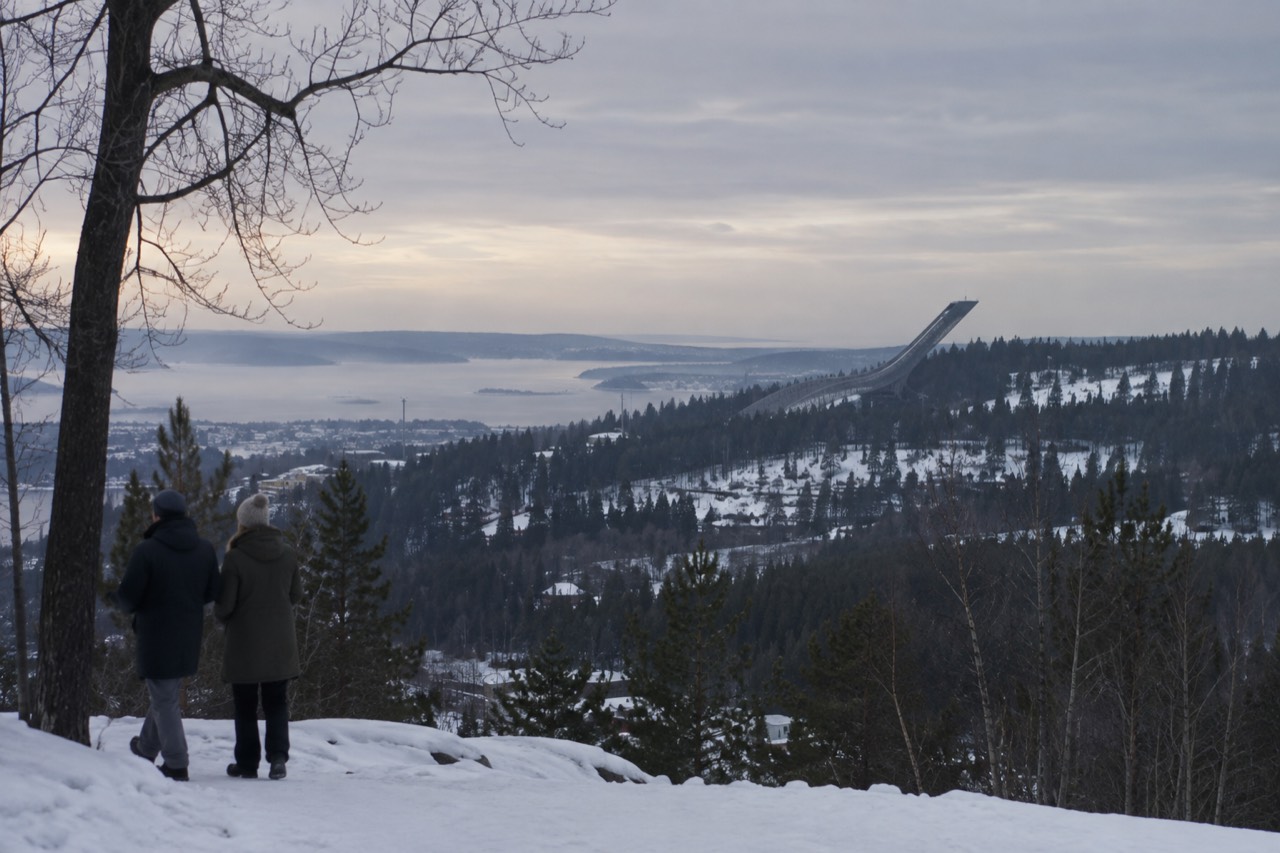 The Holmenkollen ski jump tower rising above the forested hills northwest of Oslo
