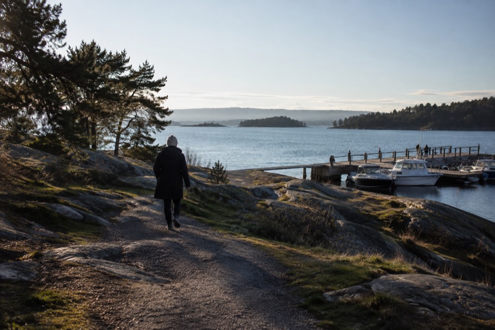 Ferry pier with moored boats and island silhouettes across the water