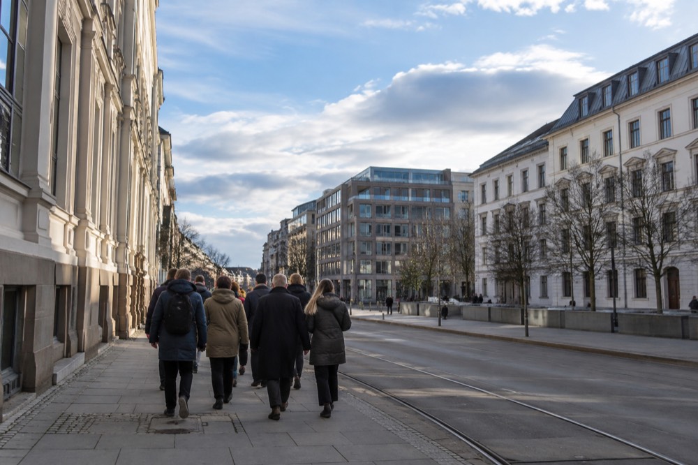 Small group of pedestrians with a guide on a city street in central Oslo