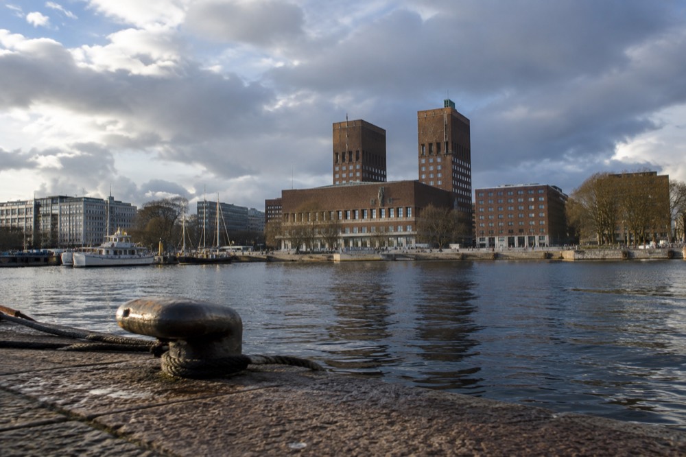 The Oslo City Hall brick towers and fjord waterfront seen from the harbor