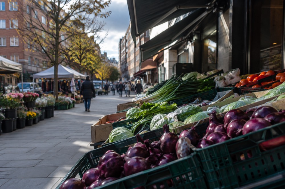 Market stalls and shopfronts on a Grønland street