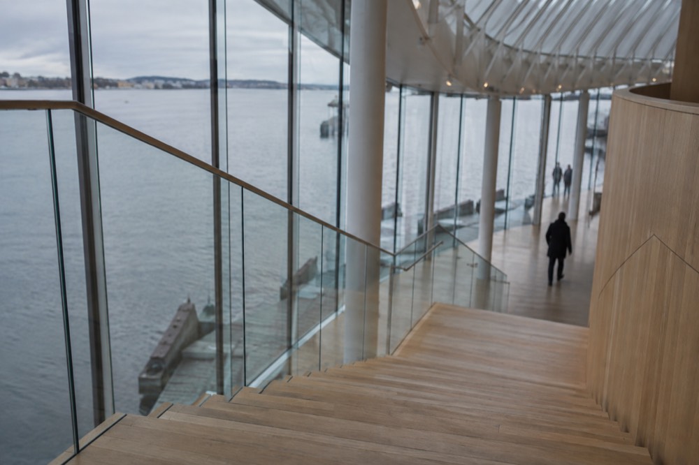 Interior staircase in a modern museum building with light wood and glass