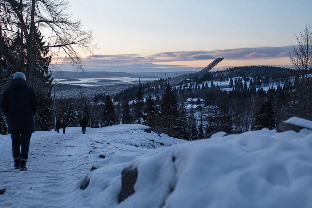 The Holmenkollen ski jump tower rising above the treeline above Oslo