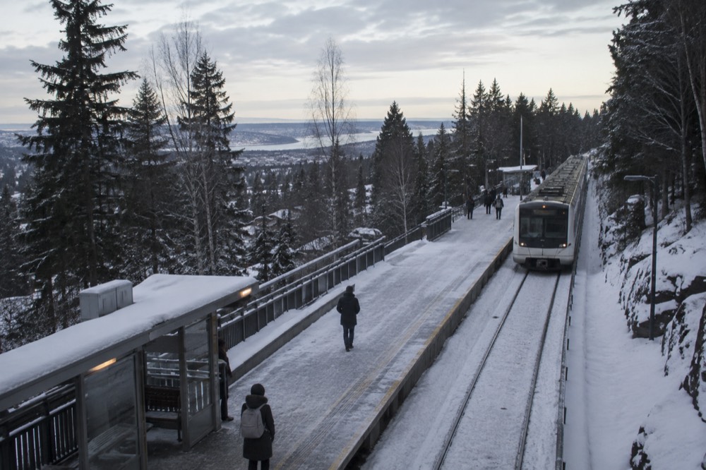 A Line 1 metro platform at Holmenkollen station in the forested hills above Oslo
