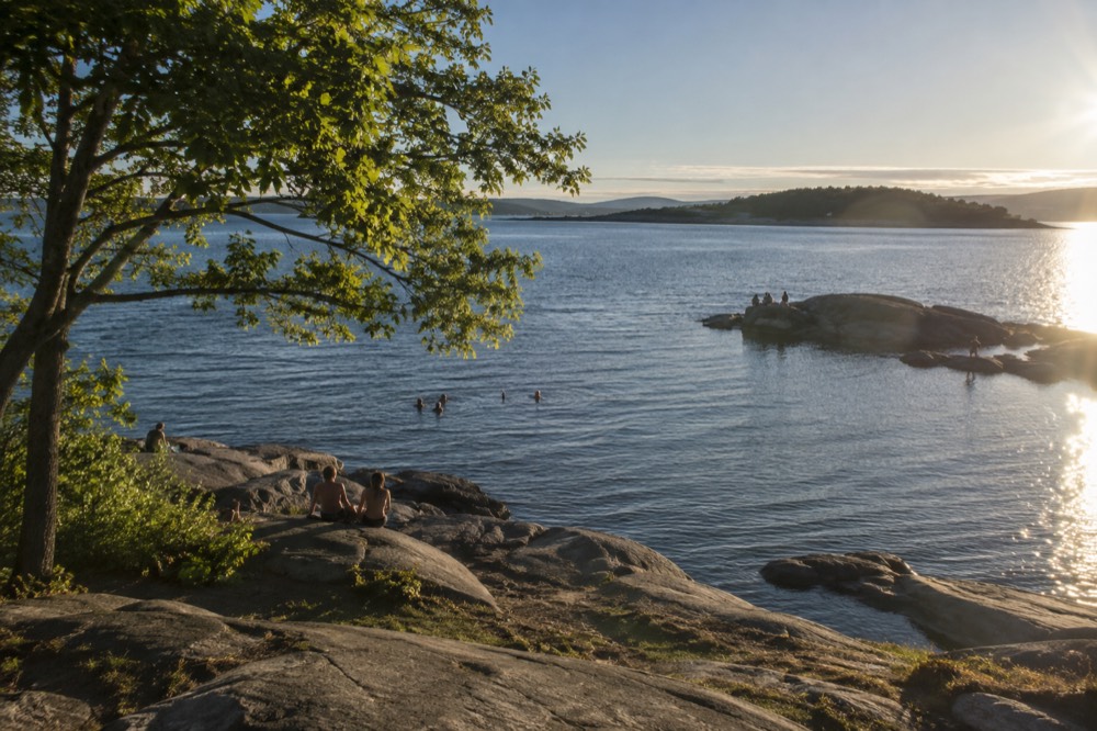 Clear water over smooth granite rocks at a small island swimming cove
