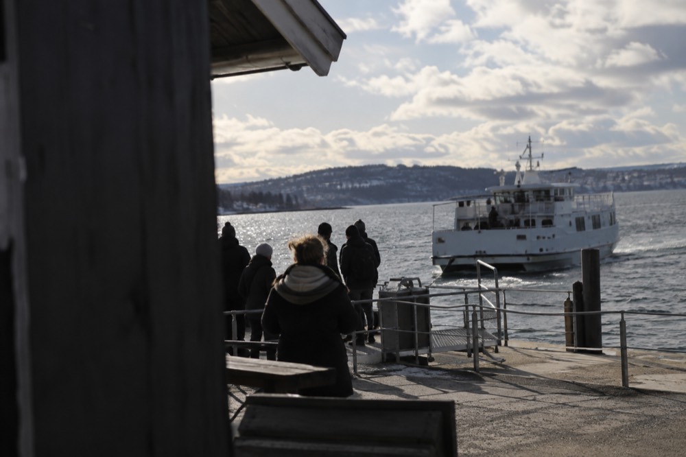 Ferry pier with passengers waiting as an island boat pulls in