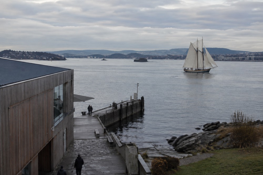 A traditional wooden sailing ship under way on the Oslofjord near the city harbor
