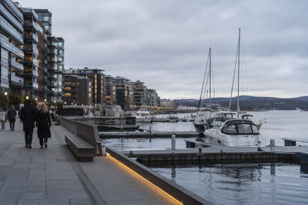 Aker brygge waterfront with moored boats and modern buildings behind