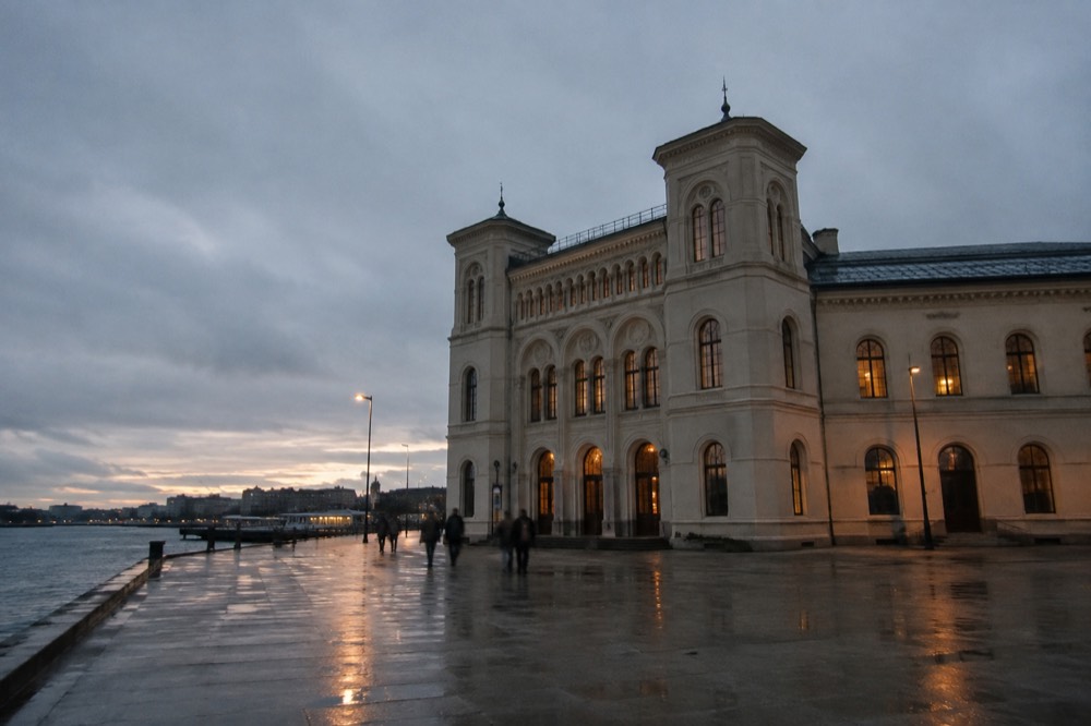 The Nobel Peace Center building on the waterfront near Oslo City Hall at dusk