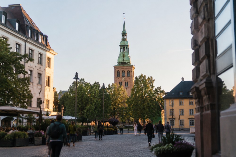 Oslo Cathedral's brick tower and green copper spire seen from Stortorvet