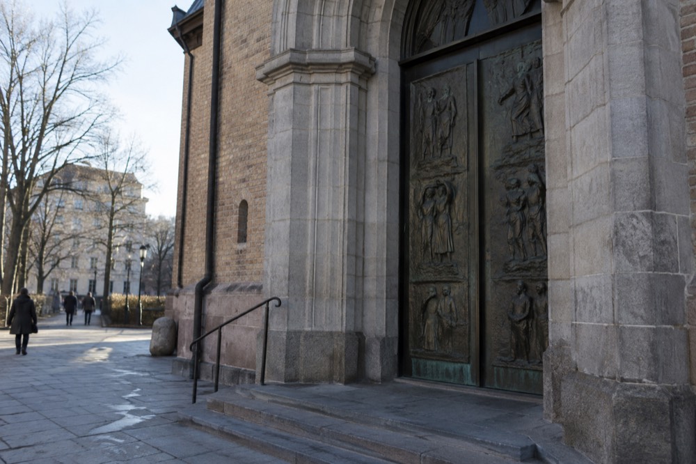 Bronze relief doors of Oslo Cathedral seen from Karl Johans gate