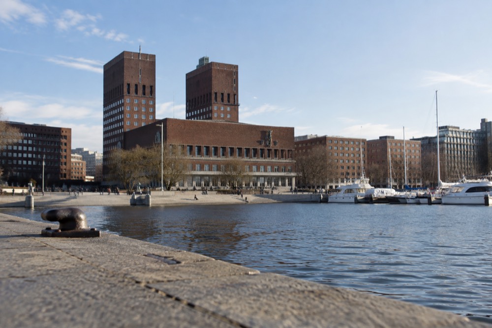 The twin brick towers of Oslo City Hall seen from the harbor plaza
