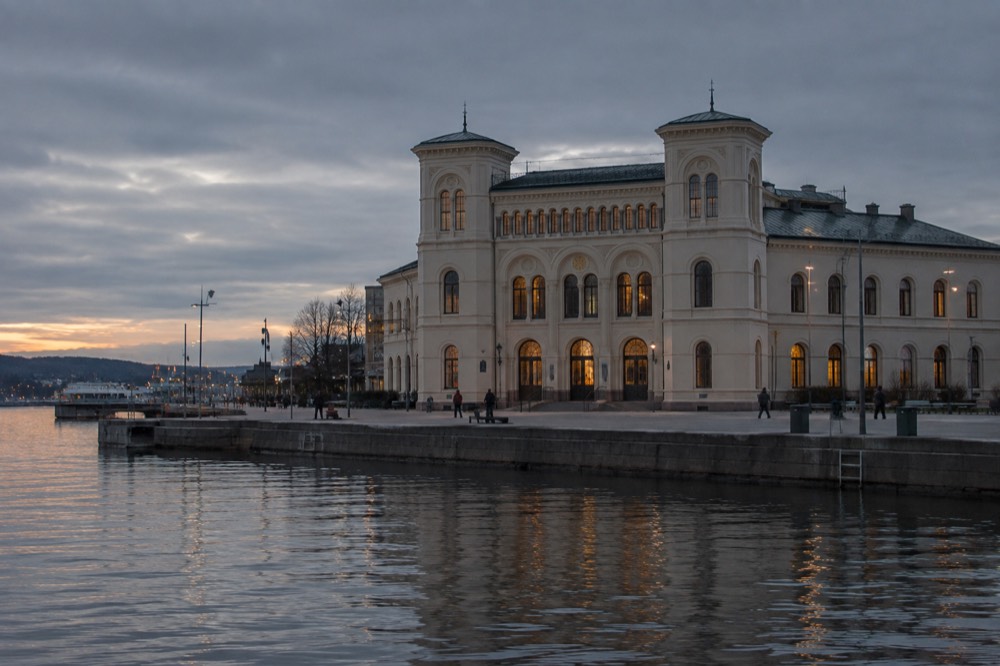 The Nobel Peace Center facade on the Oslo waterfront at dusk