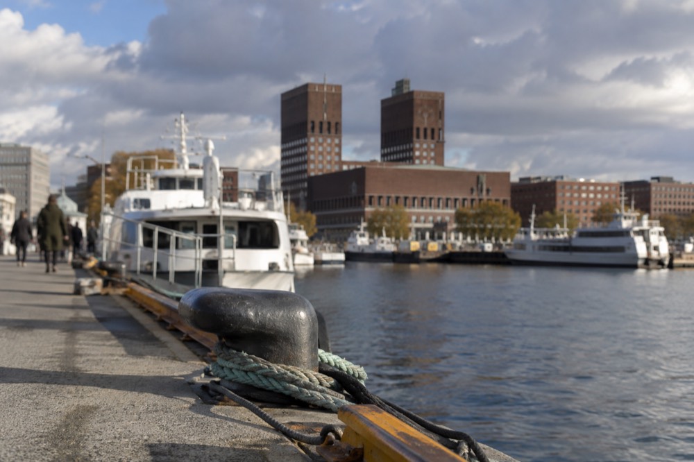 Harbor piers in front of Oslo City Hall with ferries moored at the quay