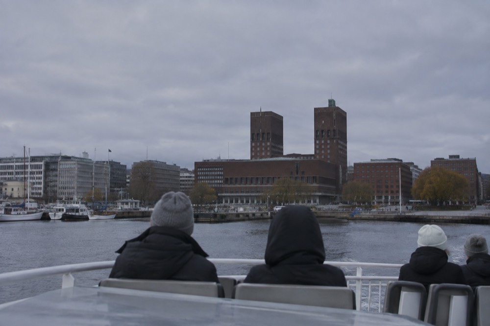 View across the harbor to Oslo City Hall from a ferry deck