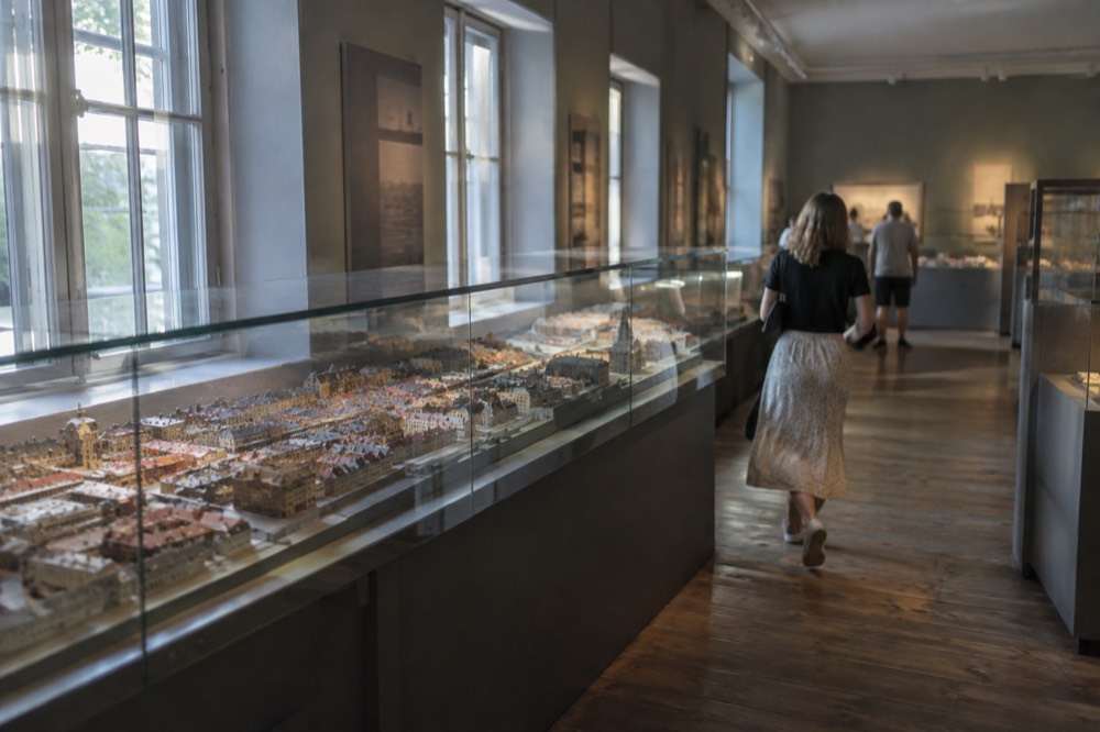 Old city model showing miniature buildings displayed in a glass case