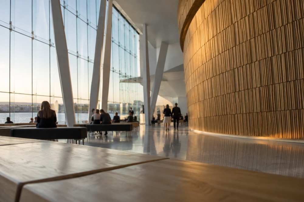 Warm oak interior of the Opera House foyer with the curved wave wall