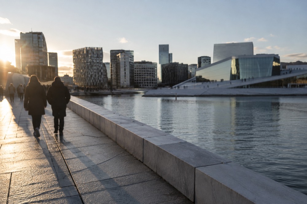 Bjørvika waterfront boardwalk with the Opera House on one side and modern towers behind