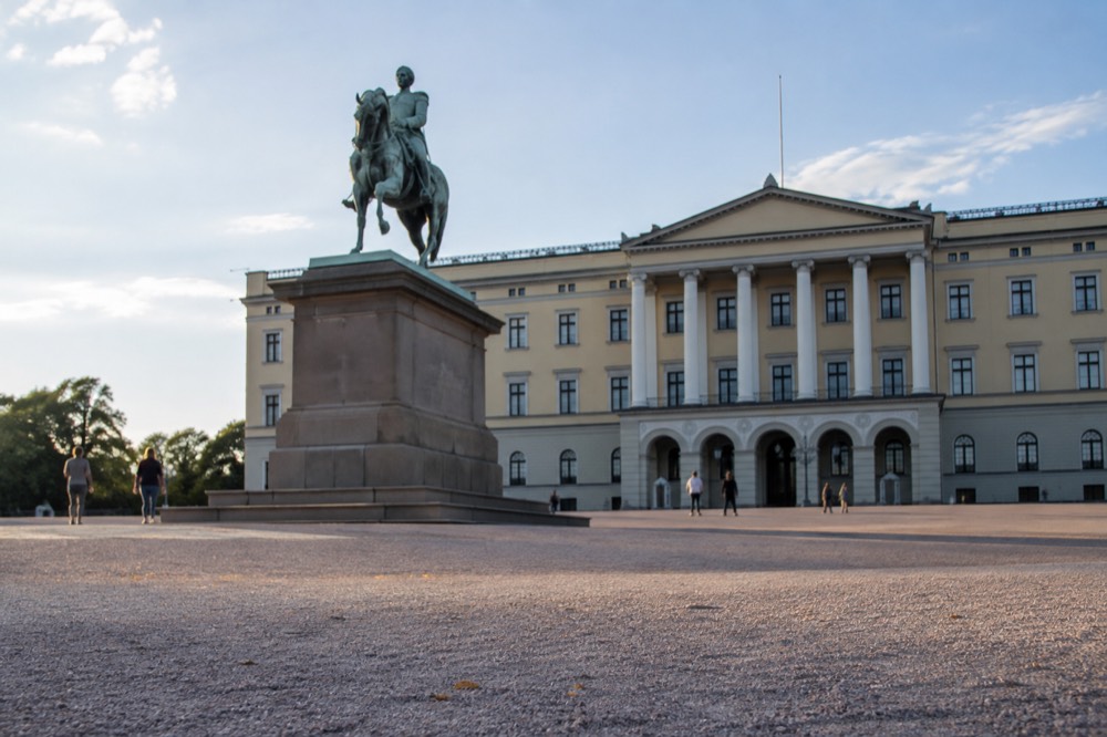 The Royal Palace facade in Oslo with the statue of King Karl Johan in the foreground