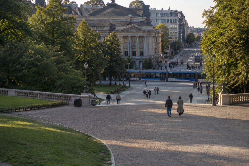 Trams and pedestrians on the street in front of the National Theatre a short walk from the Royal Palace