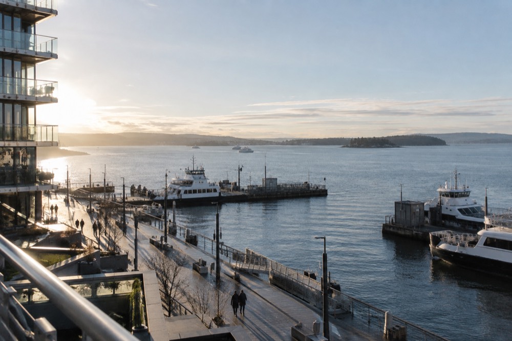 View over Aker Brygge pier with ferries and the Oslofjord in morning light