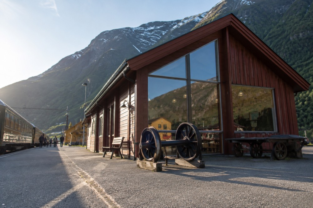A small railway museum building beside the station platform in a mountain village