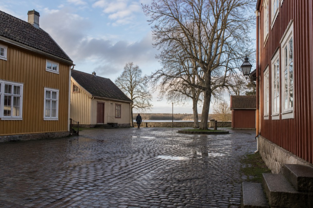 Timber buildings around a quiet cobblestone square in a fortified old town