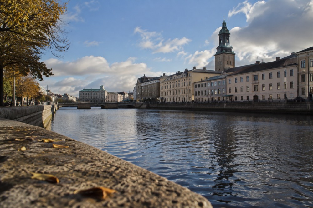 Gothenburg canal houses and a historic church seen across the water on a bright day