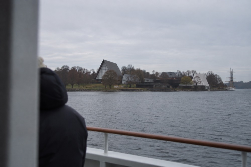 Museum buildings on a green peninsula seen from the water